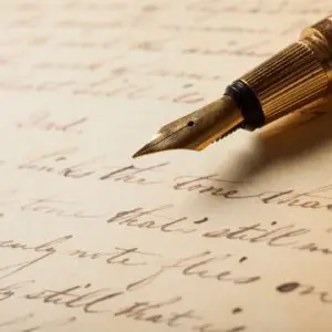 A pen is on top of an old letter.