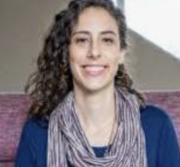 headhsot of smiling woman with brown curly hair