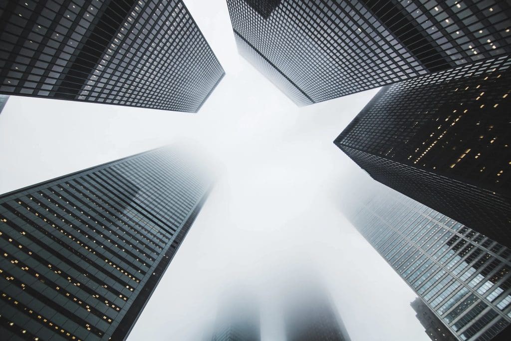 light shining through tops of skyscrapers