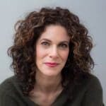 A woman with curly hair and a green sweater.