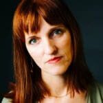 A woman with red hair and green eyes.