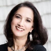 Smiling woman with long dark hair.