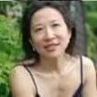 Woman outdoors, wearing a black top.