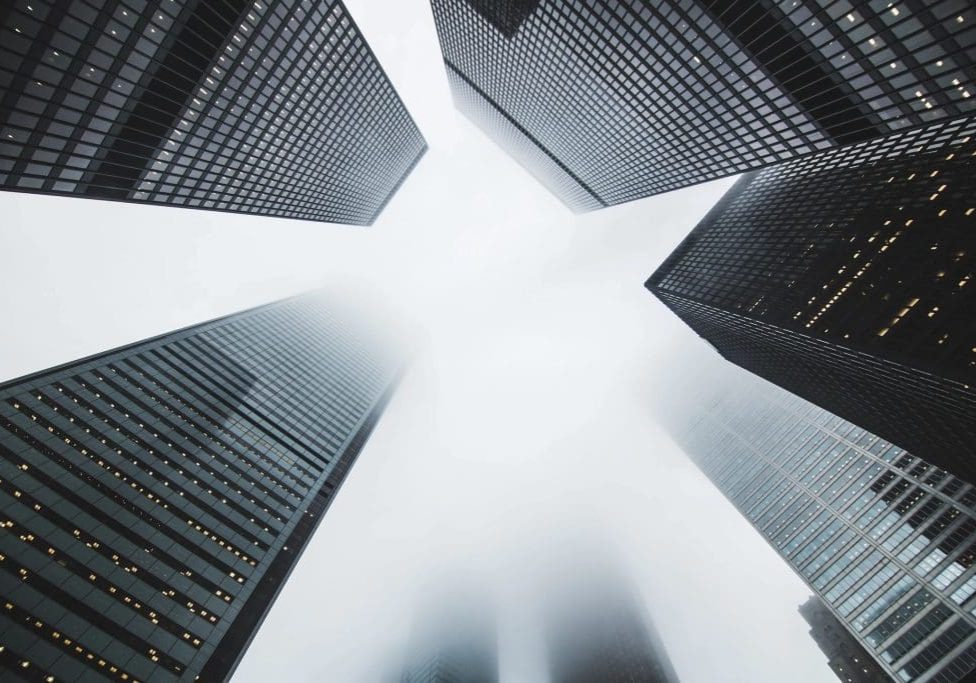 light shining through tops of skyscrapers